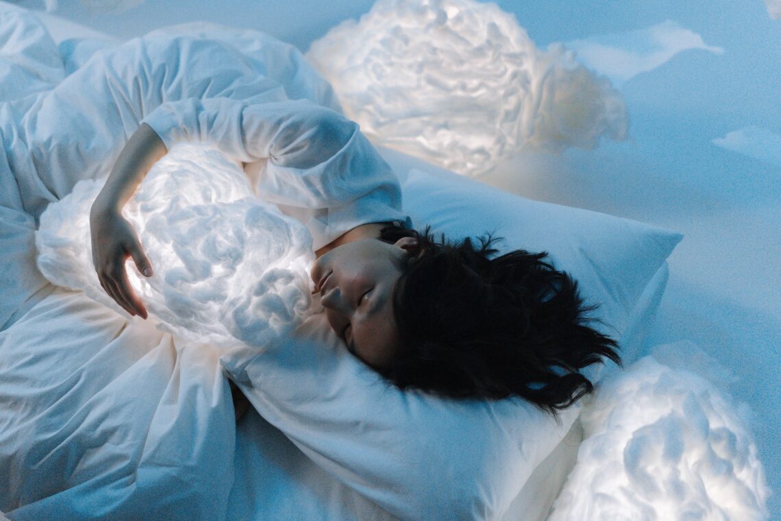 photo of a woman sleeping hugging a cloud